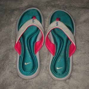 teal and pink foam flip flops from nike